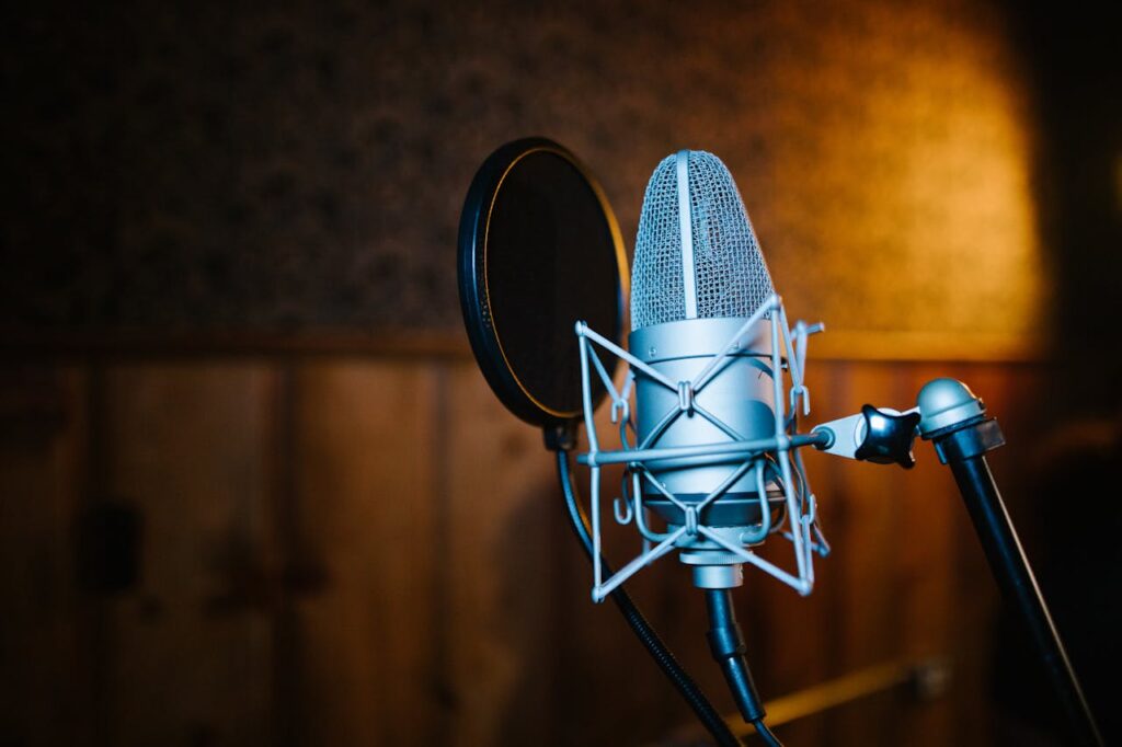 Close-up view of a professional microphone and pop filter setup in a recording studio, perfect for audio and music recording.